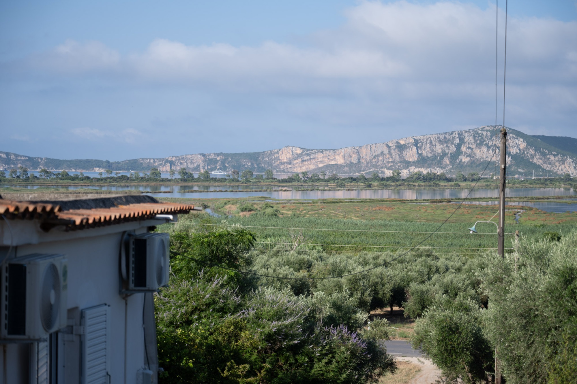 View from the terrace over Gialova Lagoon toward the cliffs of Navarino Bay